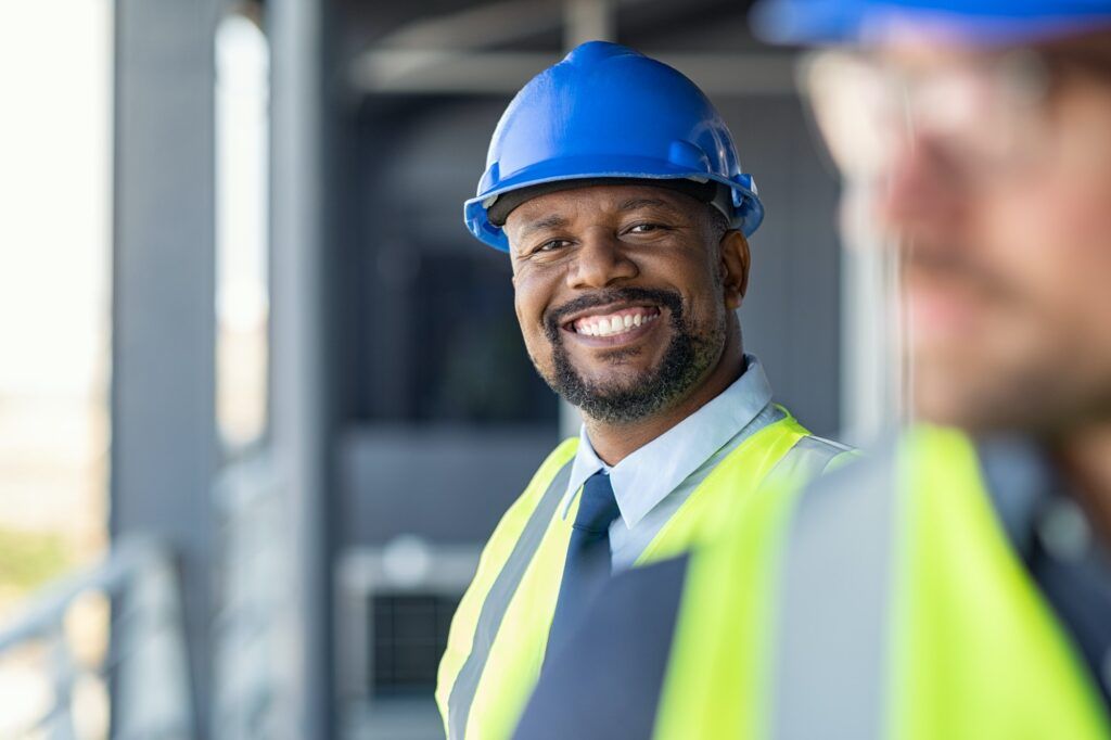 Portrait of happy engineer on site